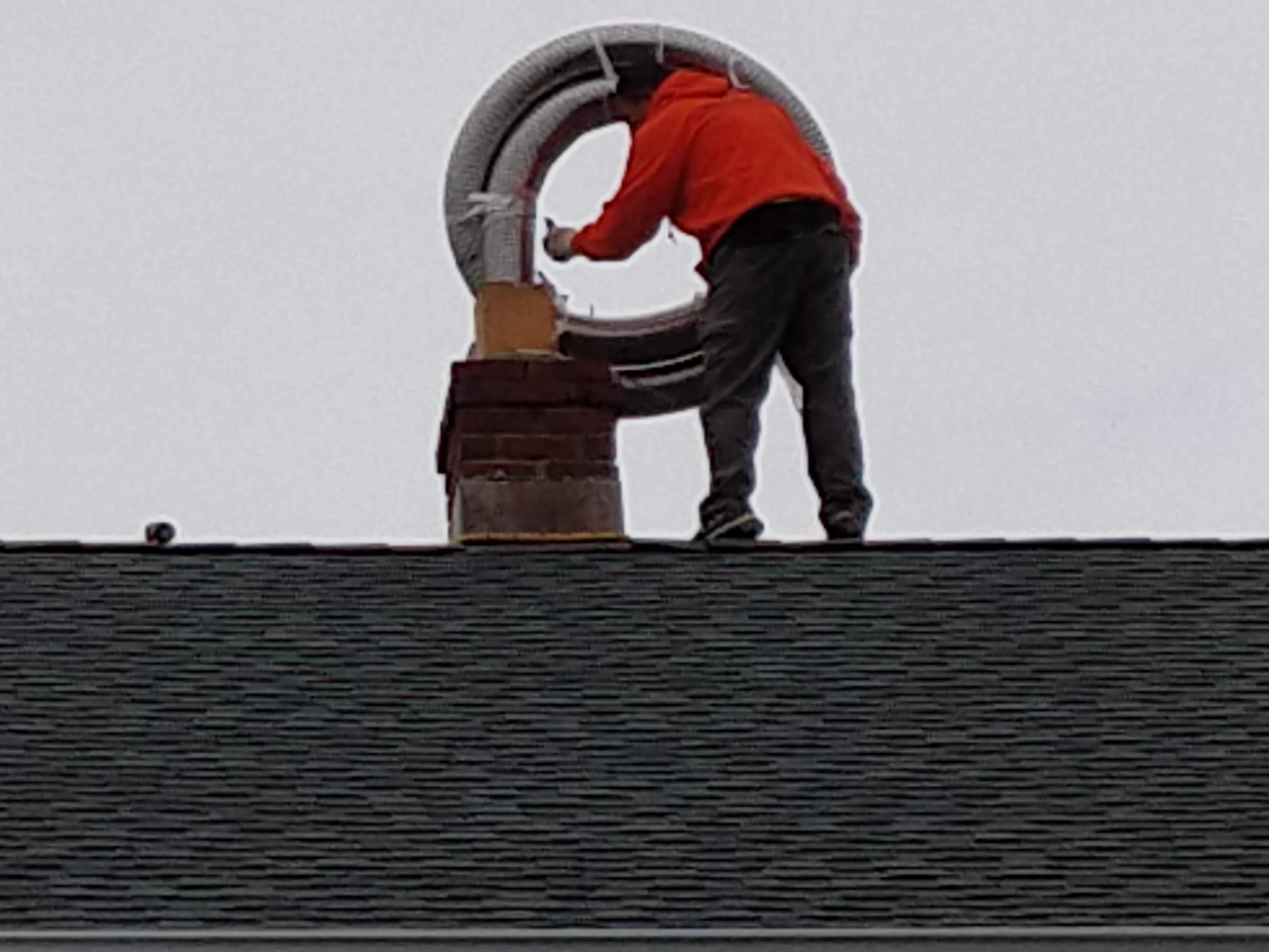 Flexible stainless chimney liner being installed in Floral Park, New York